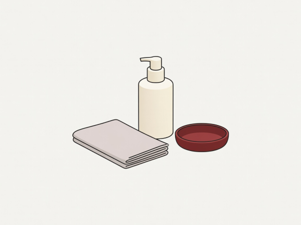 Flat illustration of a cream hand-care bottle, folded cloth and small burgundy dish